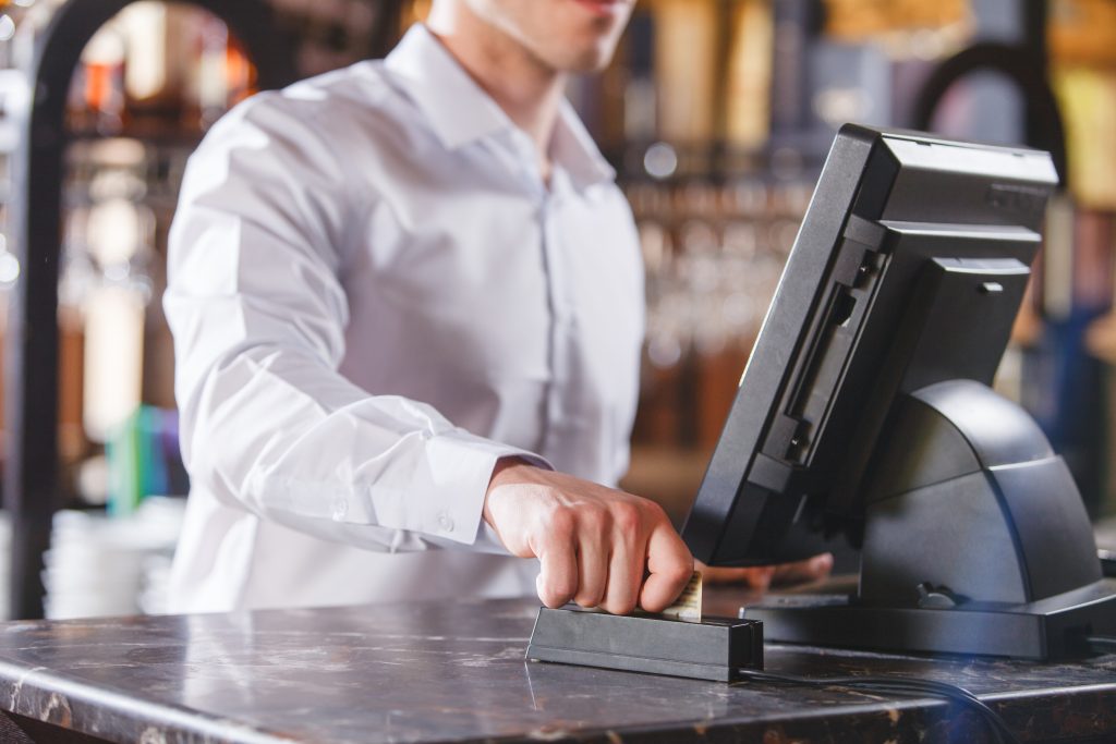 Hand Swiping Credit Card In Store